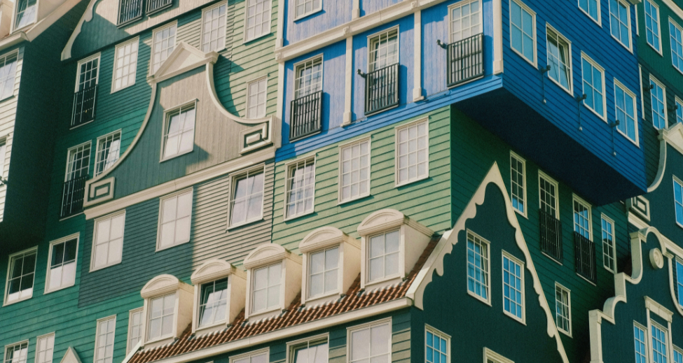 Traditional Dutch gabled building facades stacked and layered together, representing layered governance frameworks